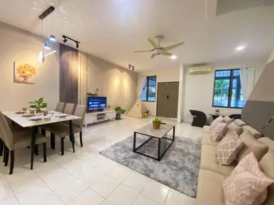 a living room with a couch and a table at 2 Storey Stylish Comfort Retreat ````AlmaImpianRia in Bukit Mertajam