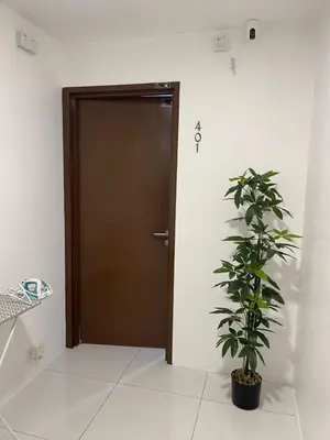 a door in a room with a plant in front of it at TDOZE Hotel in Brinchang