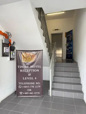 a stairway with a sign in front of a building at TDOZE Hotel in Brinchang
