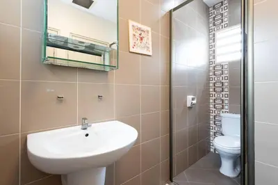 a bathroom with a sink and a toilet at Retro Homestay Ipoh - Semi D 15pax Wedding in Ipoh