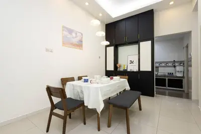 a dining room with a white table and chairs at Retro Homestay Ipoh - Semi D 15pax Wedding in Ipoh