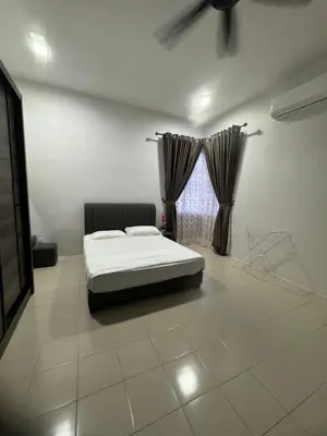 a bedroom with a bed and a window at Homestay Kakak Adek 3 in Parit Buntar