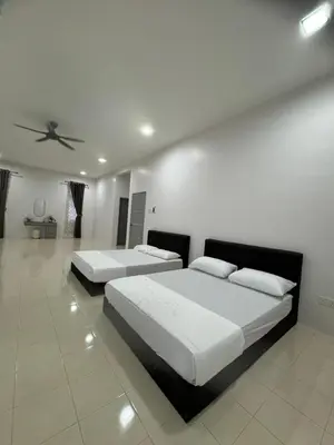 a bedroom with two beds and a ceiling at Homestay Kakak Adek 3 in Parit Buntar