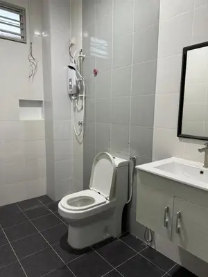 a bathroom with a toilet and a sink at Homestay Kakak Adek 3 in Parit Buntar