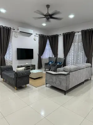 a living room with couches and a flat screen tv at Homestay Kakak Adek 3 in Parit Buntar