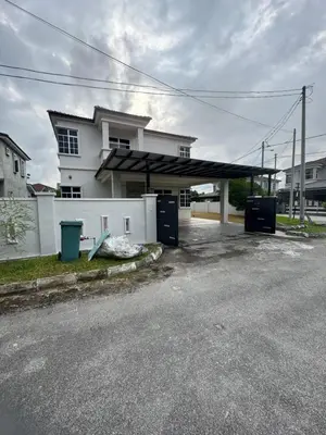 a parking lot with a gas station in front of a house at Homestay Kakak Adek 3 in Parit Buntar