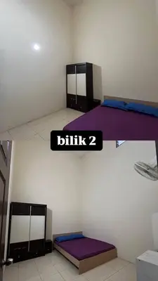 two bunk beds in a room with a sign that says blitz at Azriff homestay in Seri Iskandar