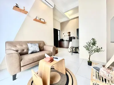 a living room with a couch and a table at Urban Suites #Walnut 1BR 1Bath suite #Infinity Pool #3pax #1Queen 1Single #Quality well maintained #Private host in Jelutong
