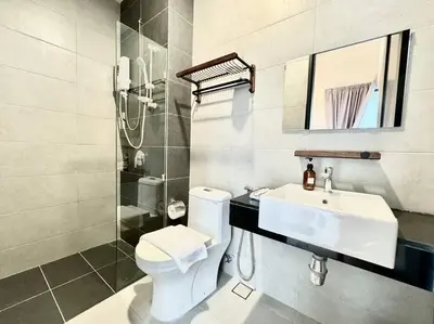 a bathroom with a white toilet and a sink at Urban Suites #Walnut 1BR 1Bath suite #Infinity Pool #3pax #1Queen 1Single #Quality well maintained #Private host in Jelutong