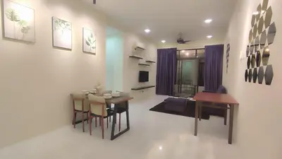 a living room with a table and a dining room at Sweet Home Ipoh Oasis Condominium in Ipoh