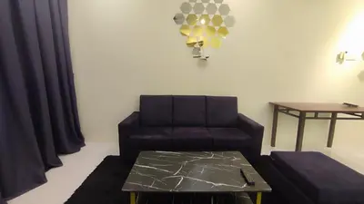 a living room with a couch and a table at Sweet Home Ipoh Oasis Condominium in Ipoh