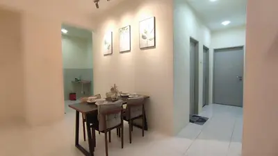 a dining room with a wooden table and chairs at Sweet Home Ipoh Oasis Condominium in Ipoh