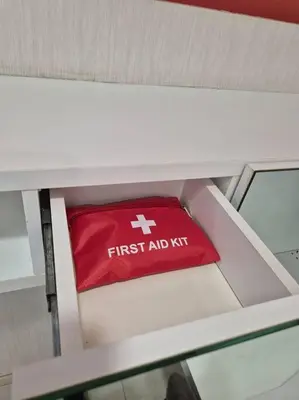 a red first aid kit sitting on a white shelf at Modern & Relax Studio Penang in George Town