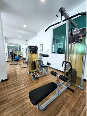 a gym with several tread machines and a mirror at Modern & Relax Studio Penang in George Town