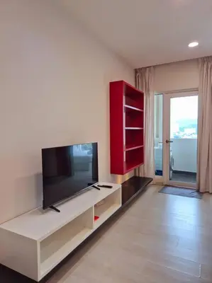 a living room with a flat screen tv and a red cabinet at Modern & Relax Studio Penang in George Town