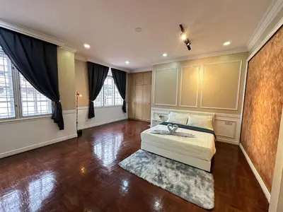 a large room with a bed and a rug at Melon Resort in Jelutong