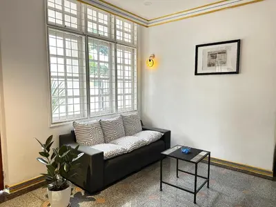 a living room with a couch and a table at Melon Resort in Jelutong