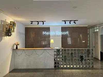 a lobby with a meloni resort sign on the wall at Melon Resort in Jelutong