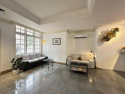 a large living room with two couches and a table at Melon Resort in Jelutong