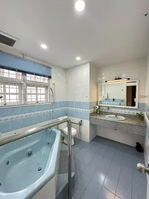 a bathroom with a tub and a toilet and a sink at Melon Resort in Jelutong