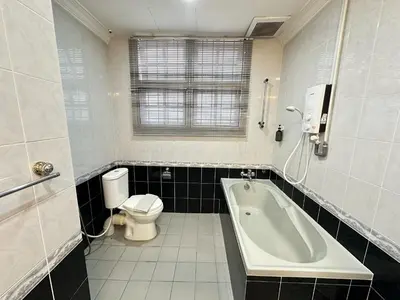 a bathroom with a tub and a toilet and a sink at Melon Resort in Jelutong