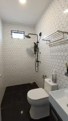 a bathroom with a white toilet and a sink at Studio Amani 2 Permatang Pauh in Permatang Pauh
