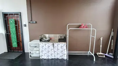 a room with a white cart and a door at Studio Amani 2 Permatang Pauh in Permatang Pauh