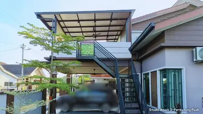 a house with a staircase leading up to a balcony at Studio Amani 2 Permatang Pauh in Permatang Pauh