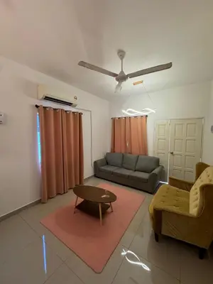 a living room with a couch and a table at FHS Homestay Trong Taiping in Bukit Gantang