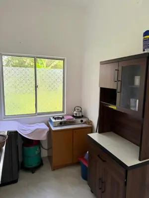 a small kitchen with a desk and a window at FHS Homestay Trong Taiping in Bukit Gantang