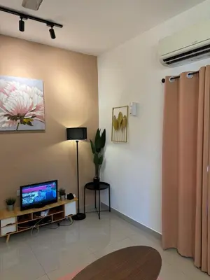 a living room with a tv and a couch at FHS Homestay Trong Taiping in Bukit Gantang