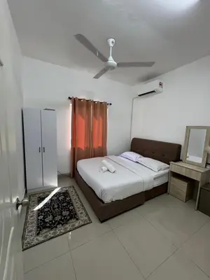 a bedroom with a bed and a ceiling fan at FHS Homestay Trong Taiping in Bukit Gantang