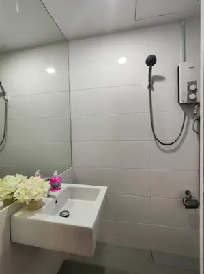 a white bathroom with a sink and a shower at NEW! Spacious 3BR Luxury Stay at Sunrise Gurney GeorgeTown in George Town