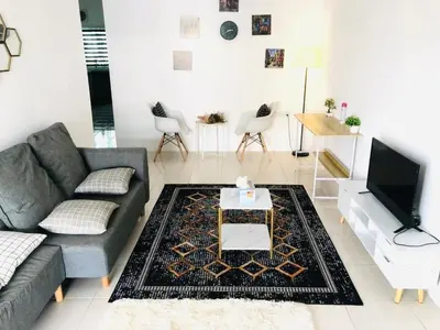 a living room with a couch and a tv at Syapins Cozy Haven Lunas Homestay Musslim Only in Lunas
