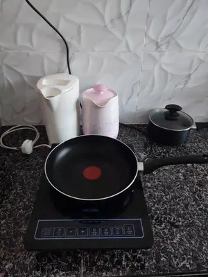 a frying pan sitting on top of a stove at Syapins Cozy Haven Lunas Homestay Musslim Only in Lunas