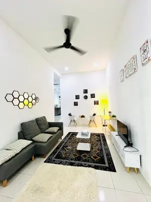 a living room with a couch and a table at Syapins Cozy Haven Lunas Homestay Musslim Only in Lunas