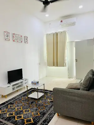 a living room with a couch and a tv at Syapins Cozy Haven Lunas Homestay Musslim Only in Lunas