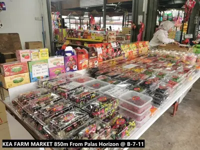 a woman standing in a store with a display of food at Palas Horizon Home B-7-11 in Brinchang
