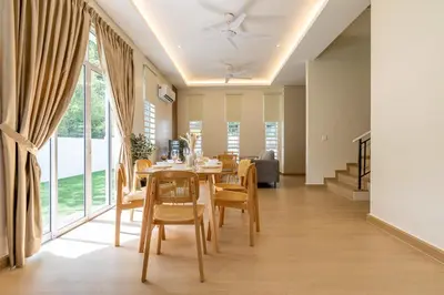 a dining room with a table and chairs at La Ferringhi Villa by BRB in Batu Ferringhi