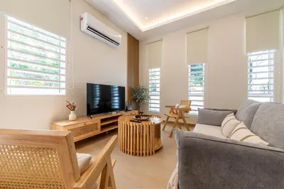 a living room with a couch and a tv at La Ferringhi Villa by BRB in Batu Ferringhi