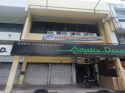 an entrance to an apartment building with a sign on it at Hotel O J Stay Guesthouse in Jelutong