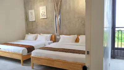 two beds in a room with a window at Silvan Garden Cameron Highlands in Tanah Rata