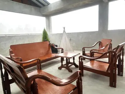 a room with three wooden chairs and a table at Silvan Garden Cameron Highlands in Tanah Rata