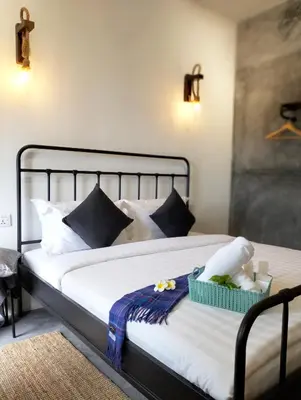 a bedroom with a bed with blue and white pillows at Silvan Garden Cameron Highlands in Tanah Rata