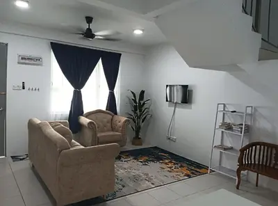 a living room with two chairs and a tv at Kak Chik Homestay Tasek Gelugor in Kampong Ayer Melintas Besar