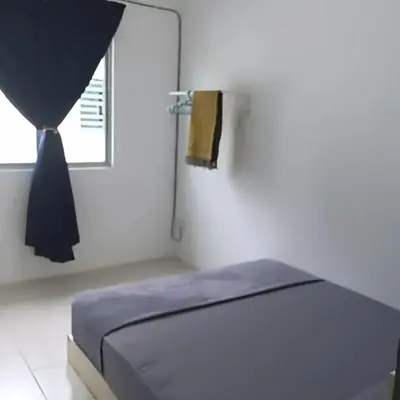 a white room with a bed and a window at Kak Chik Homestay Tasek Gelugor in Kampong Ayer Melintas Besar
