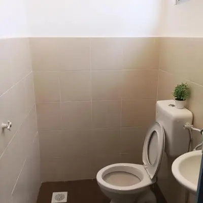 a bathroom with a toilet and a sink at Kak Chik Homestay Tasek Gelugor in Kampong Ayer Melintas Besar