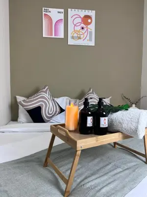 a coffee table with bottles and a glass of orange juice at Stylish&Affordable Serenity Suite #2min KekLokSi in Ayer Itam