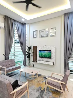 a living room with a couch and a tv at D'villa Aryan homestay with private pool in Sungai Petani