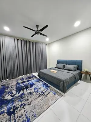 a bedroom with a blue bed and a ceiling fan at D'villa Aryan homestay with private pool in Sungai Petani